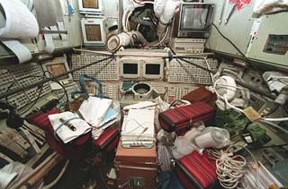 View of a control console and stowage items in the Base Block.